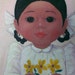 Adorable Big Eye Mexican girl painting with daisies framed in vintage white frame 1970's