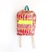 Orange and magenta abstract burlap backpack with neon yellow pouch