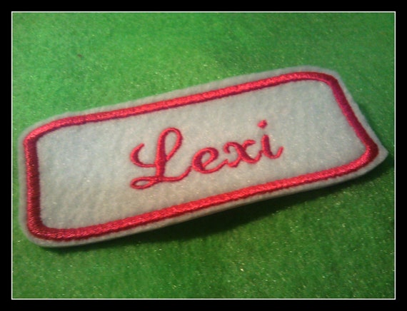 Embroidered felt Name Patch withhot pink stitching on white.