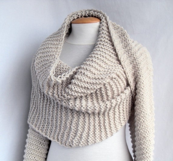 Bolero shawl scarf with sleeves at both ends in light beige.