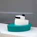 Wooden tug boat, bath tub boat in Aqua.