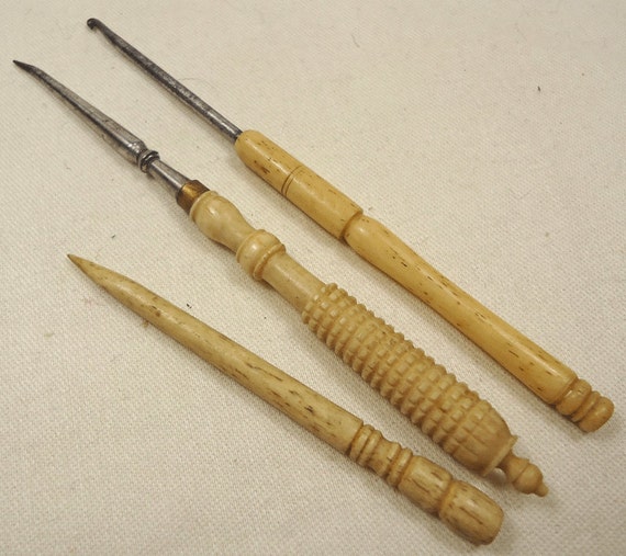 Three carved bone handled sewing tools vintage/antique