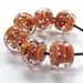 Artisan made lampwork glass bead set of 6 tiger spankle beads in orange, amber and brown with silver