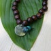 Yogi inspired wood bead bracelet with karma charm and turquoise for men or women