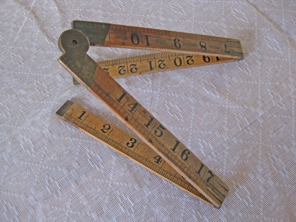 Folding wood ruler with brass hinges
