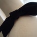 Velvet felt decorative bow to accessorize a hat.