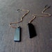 extra long black asymmetrical charm earrings on copper xl chain lightweight shoulder duster earrings