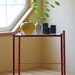 red metal and glass side table bamboo motif