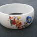 White Plastic Floral Bangle.
