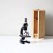 vintage skyline black microscope with cabinet