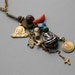 Religious amulet necklace with Buddha, Star of David,Hamsa, Cross, Ganesh and islamic symbols embellished with bone skull bead and Coral