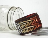 Rita cuff. Brown leather cuff woven in chevron pattern with ombre earth tones in vintage Swistraw by Ruby Buffalo.
