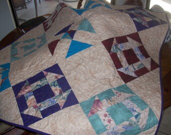 Quilted wall hanging or lap quilt, machine pieced and quilted perfect for any decor. multi-colored blocks set in beige background
