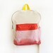 pink dyed backpack with orange pouch