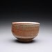 chawan, tea bowl, pottery bowl with layered orange shino glazes
