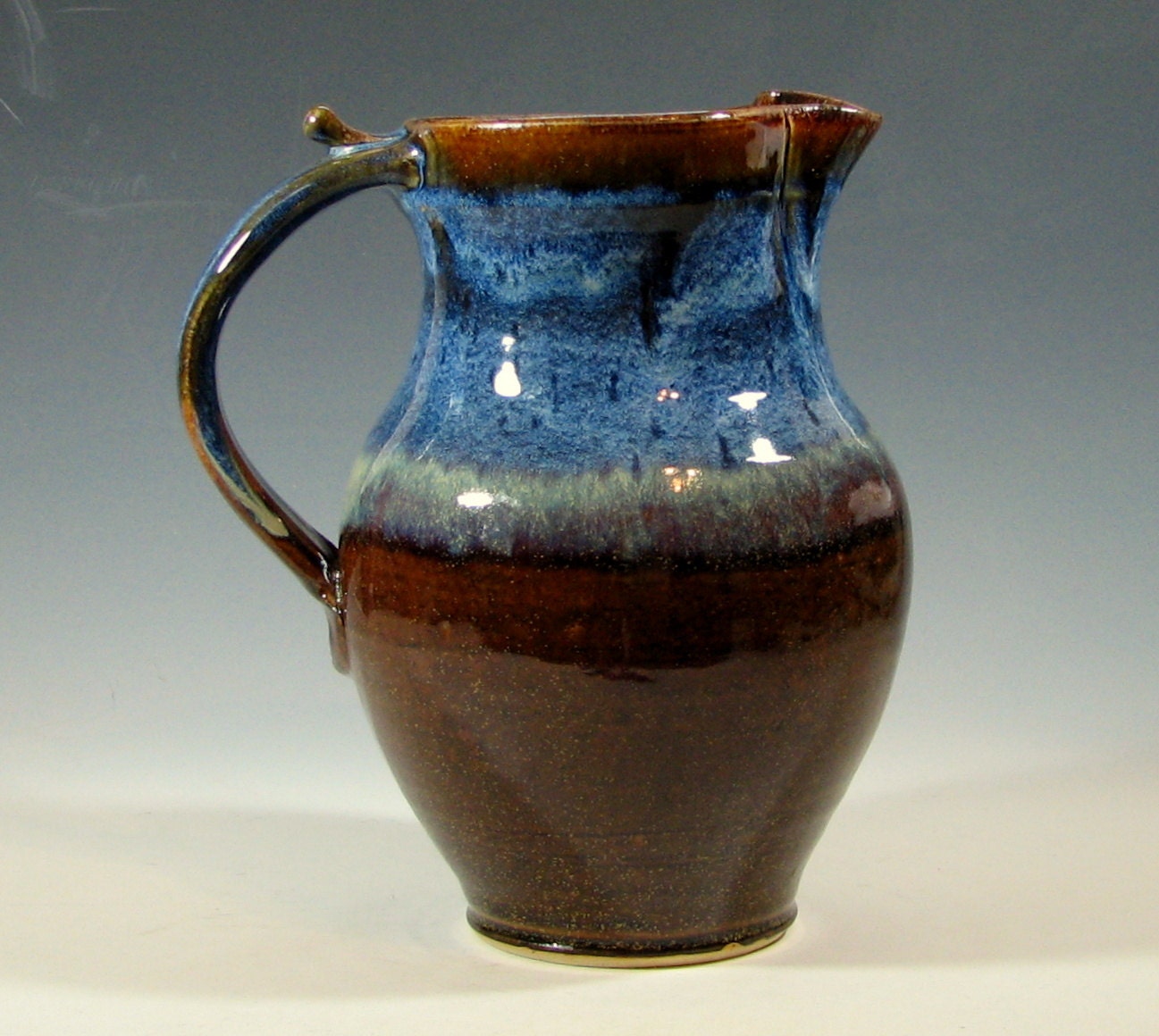 Pitcher ceramic jug drinks serving glazed in brown and blue