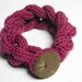 Chain knitted and knotted wool yarn bracelet fuchsia, fabric covered button, knitted jewelry, pink flambe. Knitted jewelry