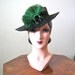 1940s Hat / Black toy tilt hat with emerald ostrich cockade and back strap
