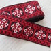 2.25 yards of wide embroidered trim - red, black, and white
