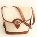 Dooney and Bourke Cream Pebble leather and tan color leather trim Cross Body Shoulder Bag.