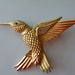 Hummingbird brooch pin. Gold tone metal, rhinestones.