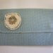 Soft Aqua blue Linen Clutch purse with fabric flower. Inside lining cream cotton with black typo