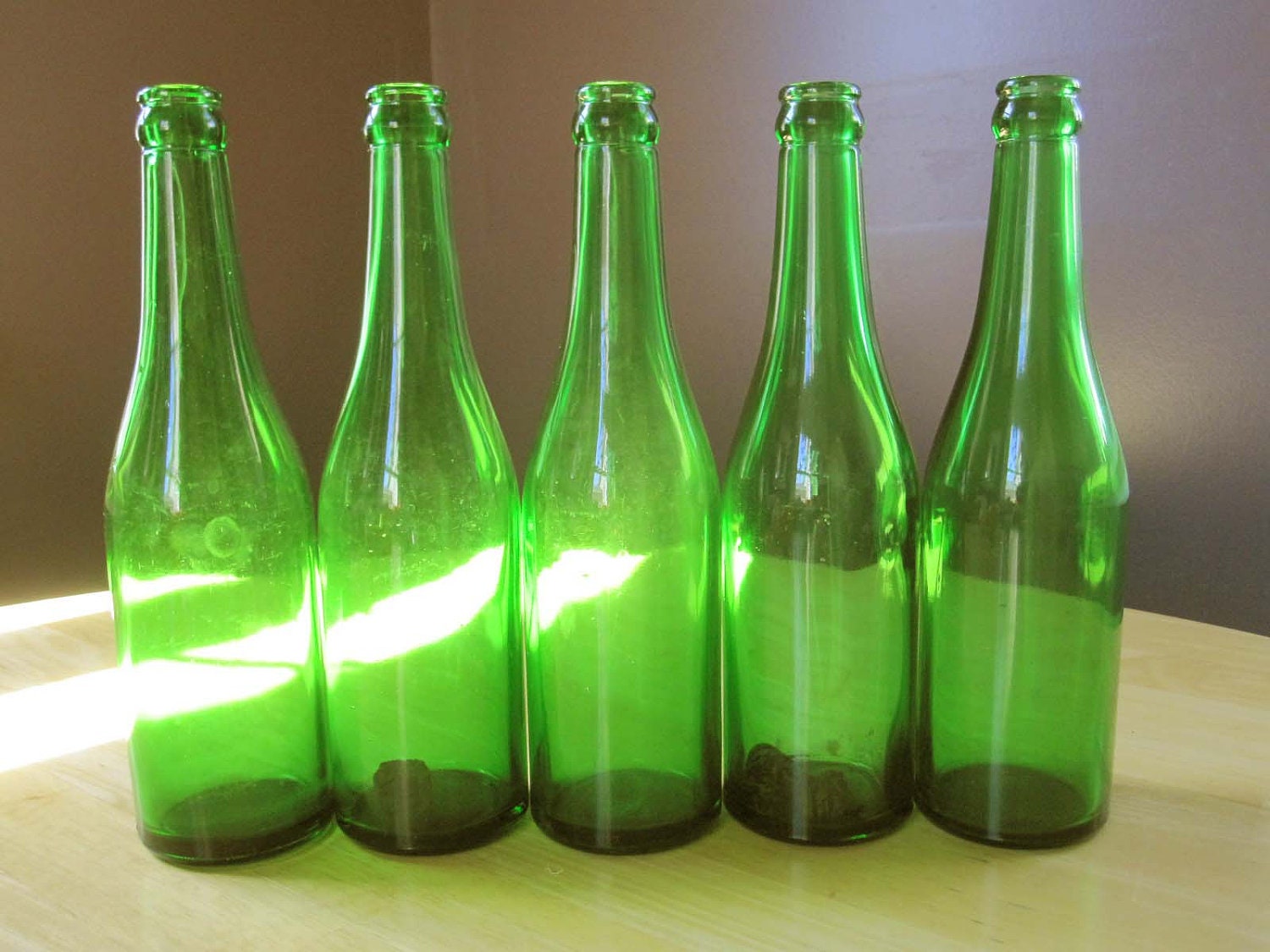 Five Simple Dark Green Bottles Hanging on the by TheBrownSuitcase