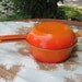 Flame, orange enamel on cast iron, Cousances, sauce pan and skillet/lid