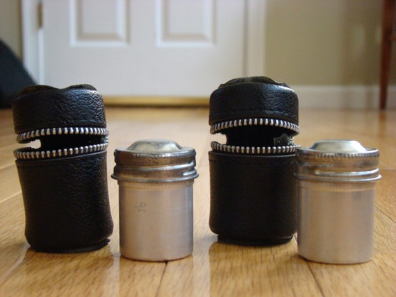 Vintage 35mm metal film canisters with leather zip cases