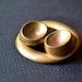Antique large pierced oval and round brass button X 1