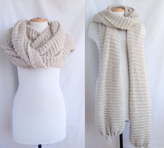 Bolero shawl scarf with sleeves at both ends in light beige.