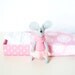 White mouse plush in matchbox bed patterned pink