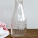 Vintage embossed milk bottle
