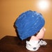 1950s dark blue turban style woman's hat with bow on backside, made of a velvet type material, vl team