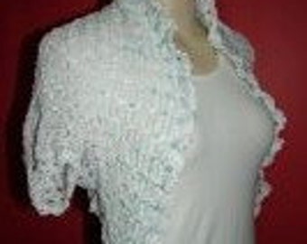 white shrug/bolero jacket with blue flower on back