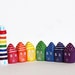 Seven little clay houses and a striped lighthouse - rainbow colors