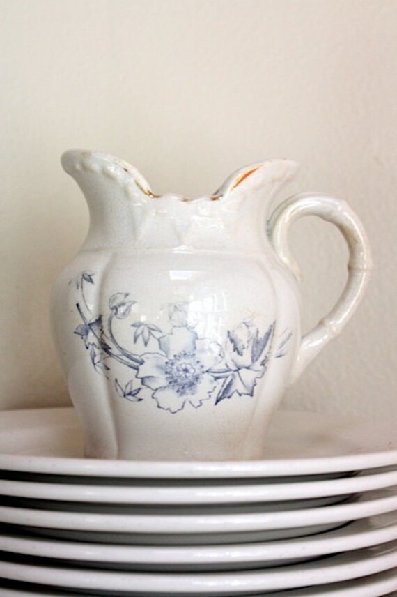 Vintage creamer pitcher with faded blue floral motif