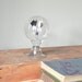 Vintage solar radiometer light bulb with black and white flags inside - industrial decor curiosity
