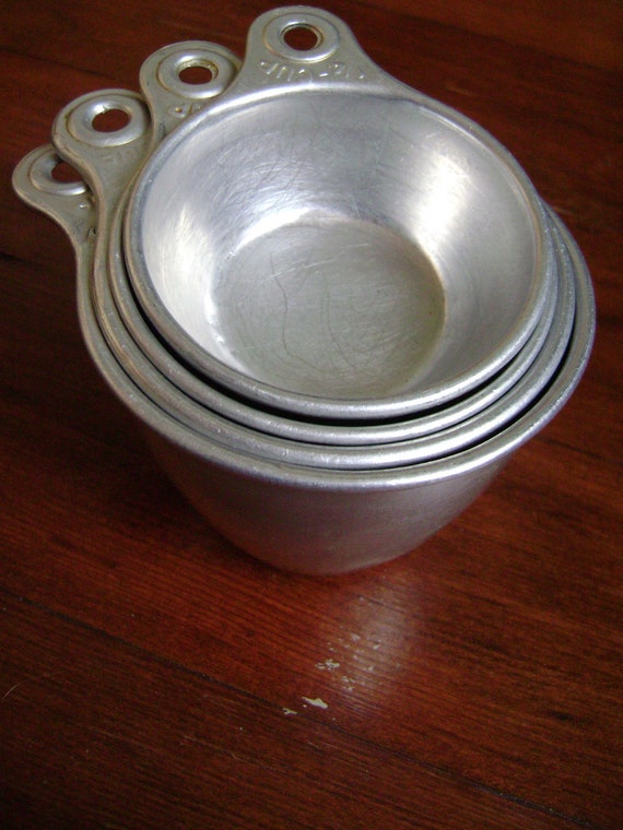 set of four vintage aluminum measuring cups