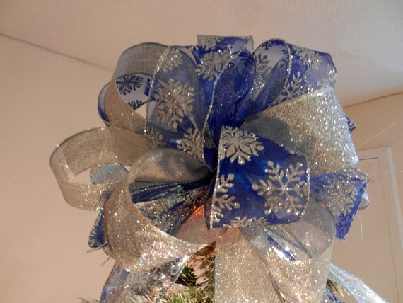 large christmas tree topper bow made of a sheer blue ribbon large christmas tree topper bow made of a sheer blue ribbon