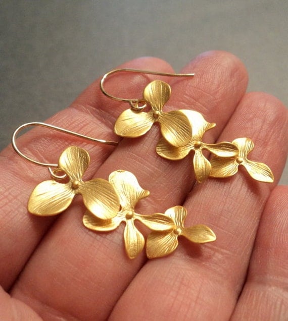 Gold orchid flower earrings. Long dangles drops on french