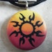 Tribal Sunset Sun hand carved on a polymer clay yellow orange and red color background. Pendant comes with a FREE 3mm necklace