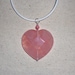 Pink faceted rose quartz heart pendant on a white leather cord semiprecious stone jewelry packaged in a colorful gauze gift bag 550A