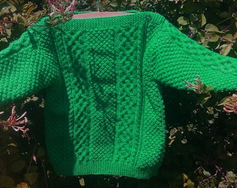 Child's toddlers boys girls handknit bright green emerald St Patricks Day aran cable sweater jumper with slash neckline. St Paddy Patty Day