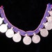 Purple string of coins