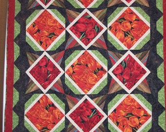 Quilted wall hanging or lap quilt. Machine pieced and quilted in beautiful red and orange tulips