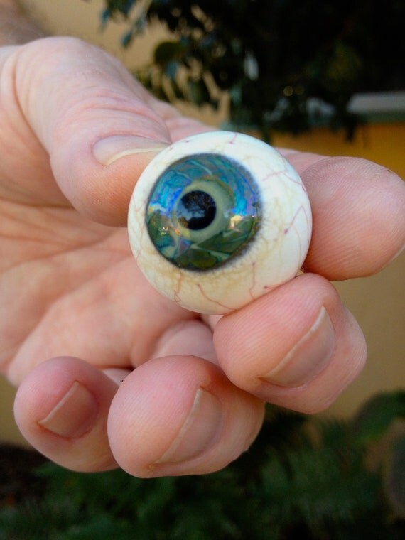 Stunning lampwork glass eye marble with green iridescent iris.