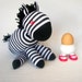 Sock animal, sock zebra, sock monkey, soft plush toy for children. Black and white.