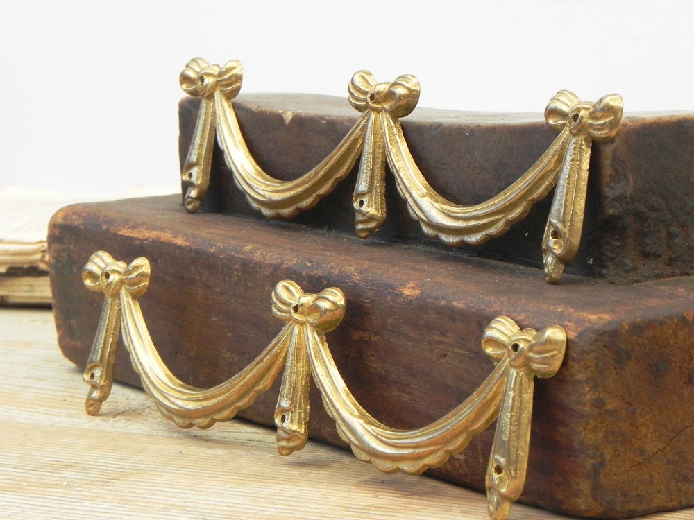 2 brass furniture ornaments