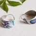Blue earrings made from a Dutch cookie tin